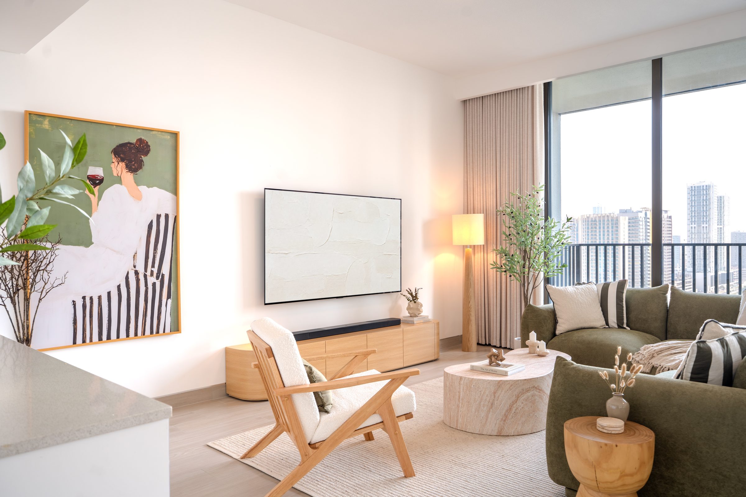 Furnished Dubai apartment living room with olive green sofa and oak TV unit
